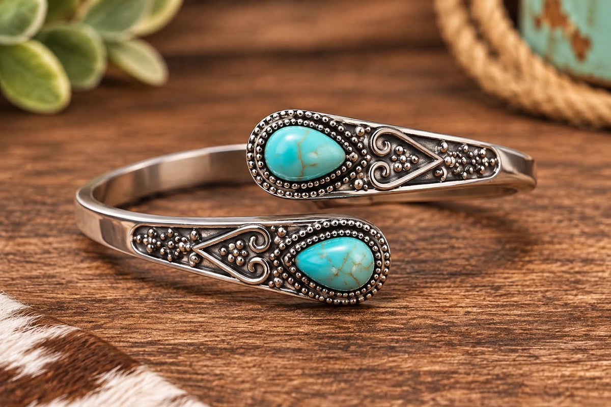 Turquoise teardrop stone silver cuff bracelet with scrollwork detailing