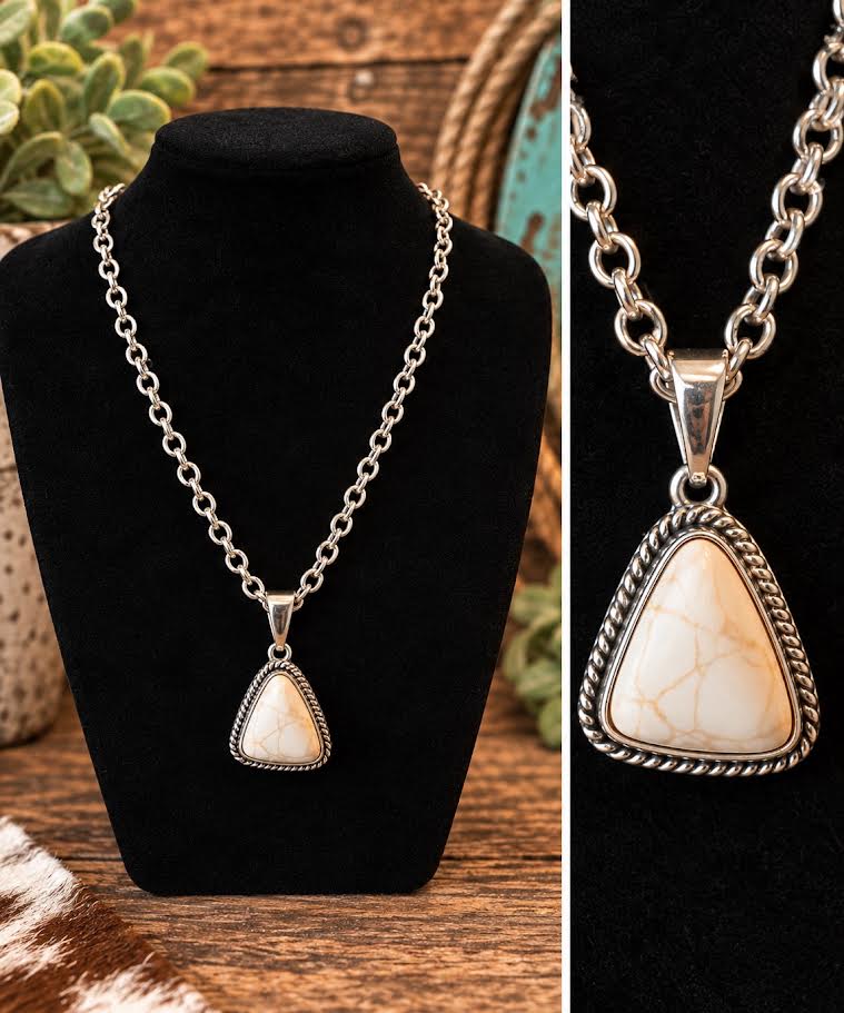 White stone triangle pendant necklace on chunky silver link chain with close-up detail of rope-edge bezel setting