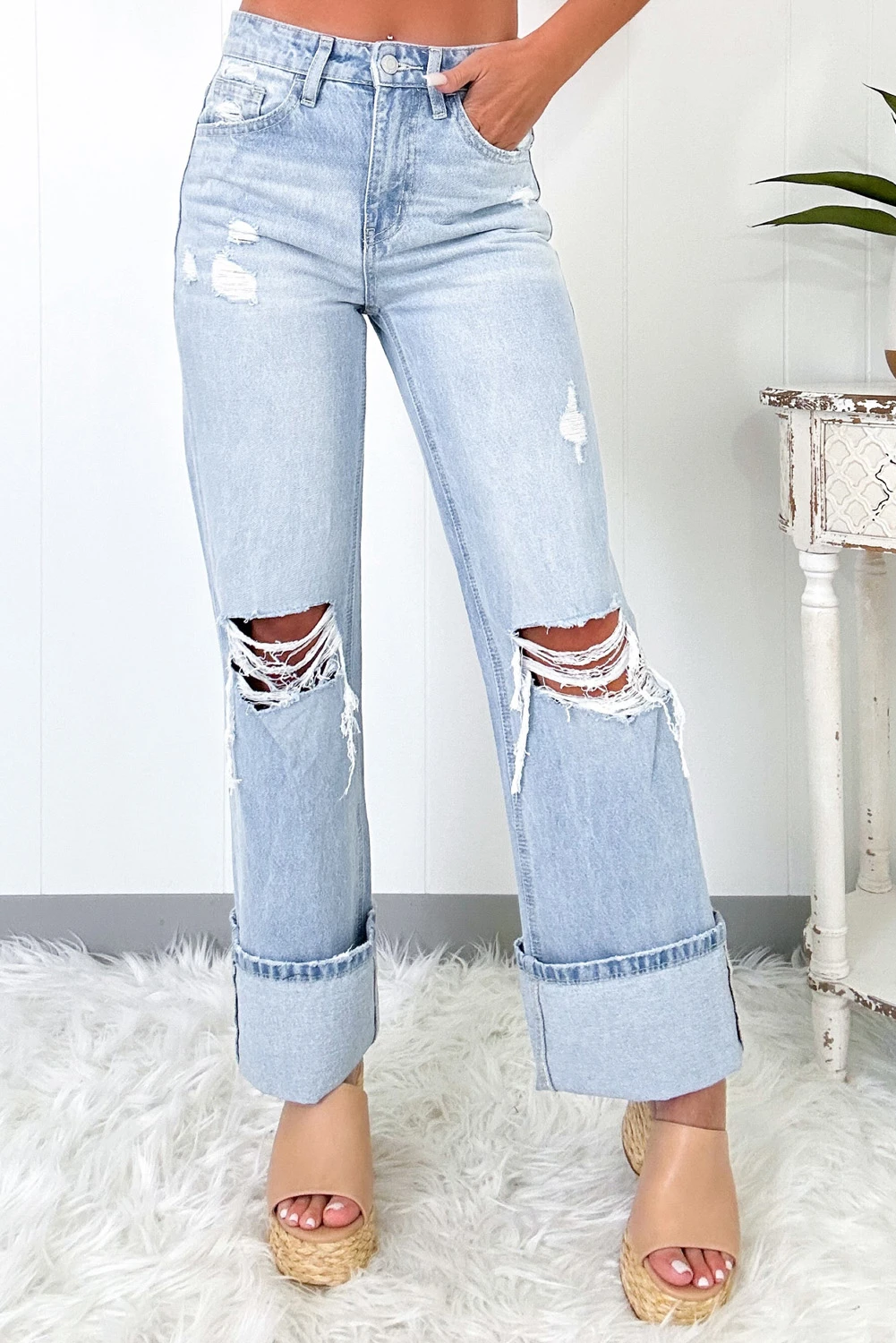 Front view of light wash distressed high-rise wide leg jeans with cuffed hem
