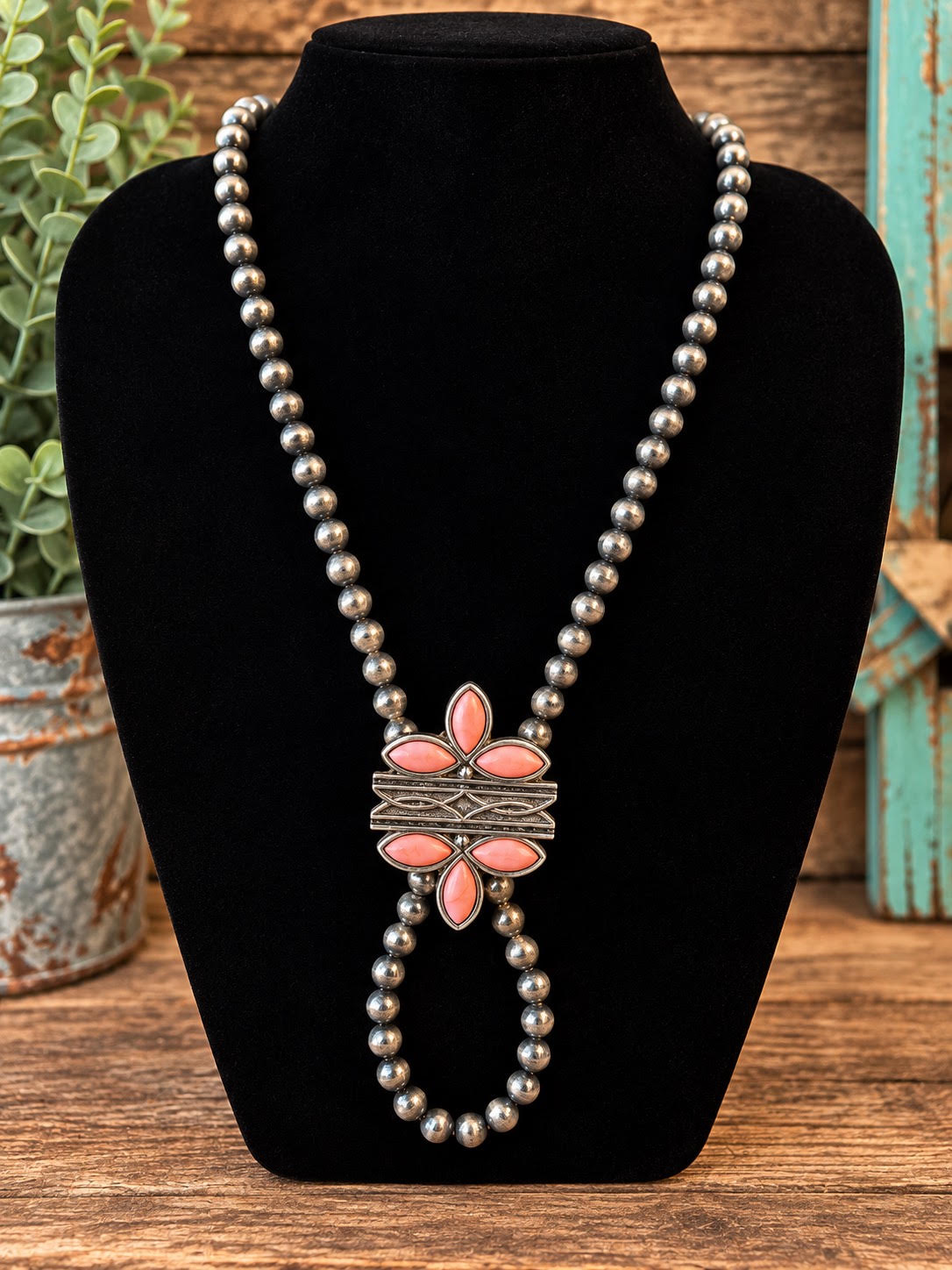 Coral flower Navajo pearl bolo necklace with oxidized silver beads and marquise coral stone pendant on black jewelry bust